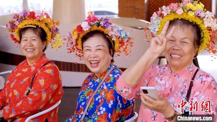 图为游客体验“簪花围”头饰。黄智渊 摄