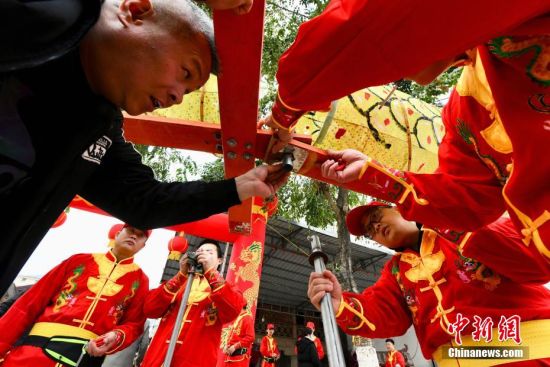 图为当地民众将板凳龙圈灯进行接龙。中新社记者 王东明 摄