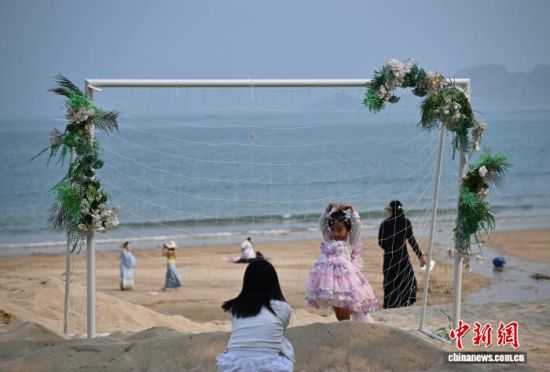 4月11日，小朋友在平潭坛南湾景区拍照留念。中新社记者 张斌 摄